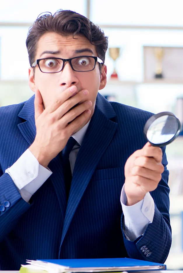 Finding Missing Dental Payments | Monthly Deposit Reconciliation | Stellar Accounts Corp Bookkeeper examining financial records with a magnifying glass to find missing deposits and reconcile dental clinic accounts accurately.