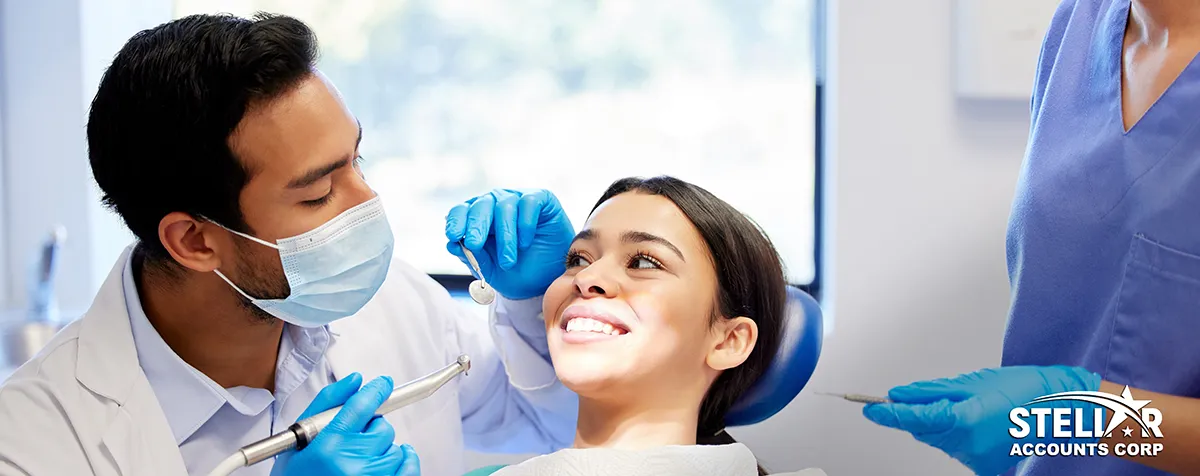 A dentist and patient smiling in a bright dental office — representing professional bookkeeping services for dental practices in Vancouver by Stellar Accounts Corp.