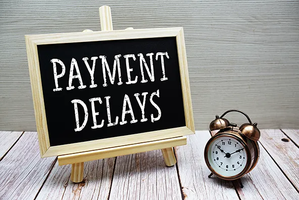 Payment Delays and Timing Gaps | Bank Reconciliation Tips | Stellar Accounts Corp Chalkboard sign showing “Payment Delays” beside a clock, symbolizing timing gaps in bank deposits and reconciliation for dental clinics.
